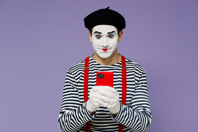 Sad mime trying to use voice activated search on his mobile phone